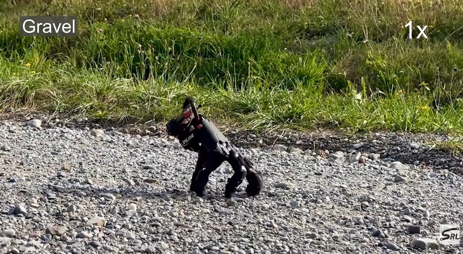 a robot shaped like a human hand walks on gravel